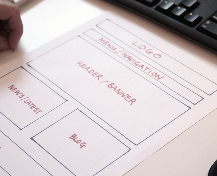 Cunningly Good Group marketing agency in Perth, Scotland, showing a PC keyboard with a website draft written on paper.