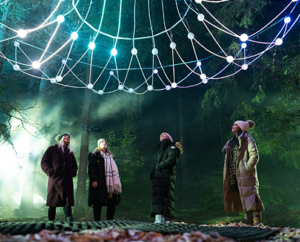 Cunningly Good Group PR agency - visual of girls looking up at a beautiful light installation at The Enchanted Forest 2025 public relations campaign.