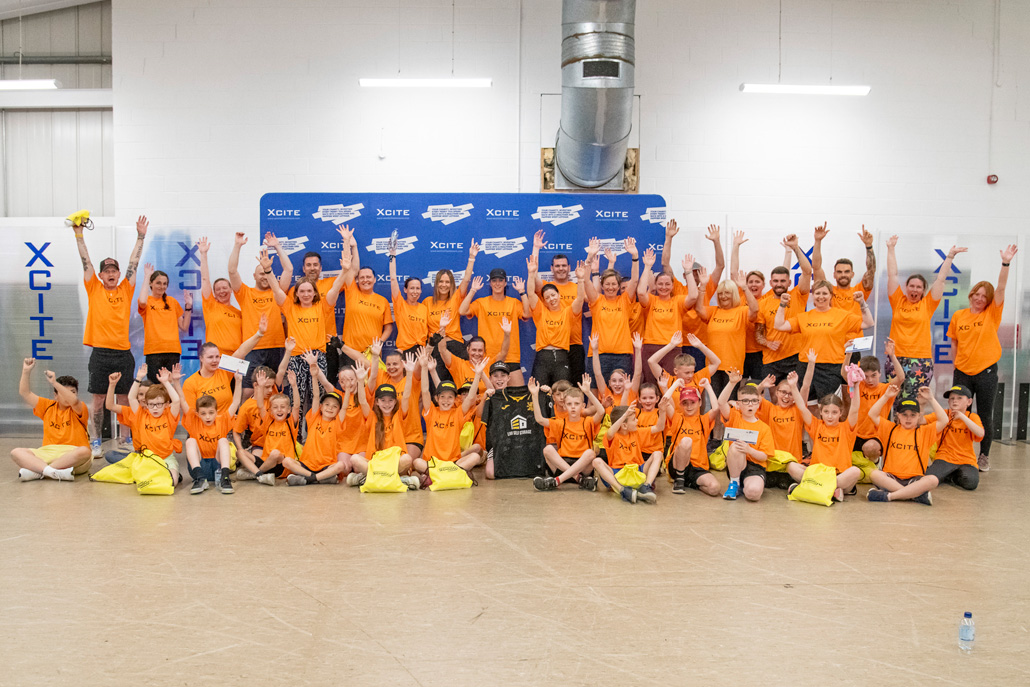 West Lothian Leisure community event participants wearing orange T-shirts during an internal communications project by Cunningly Good Group.