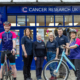 Cancer Research UK staff and cyclists outside the charity's Pitlochry shop celebrating the partnership with Etape Caledonia 2025.