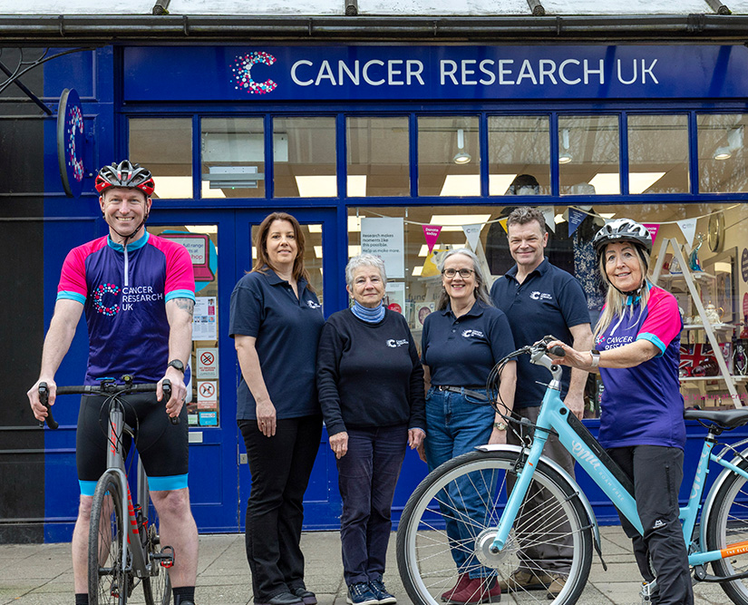 Cancer Research UK staff and cyclists outside the charity's Pitlochry shop celebrating the partnership with Etape Caledonia 2025.
